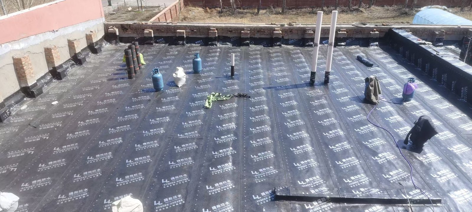 Completed waterproofing roof with pipe penetrations sealed