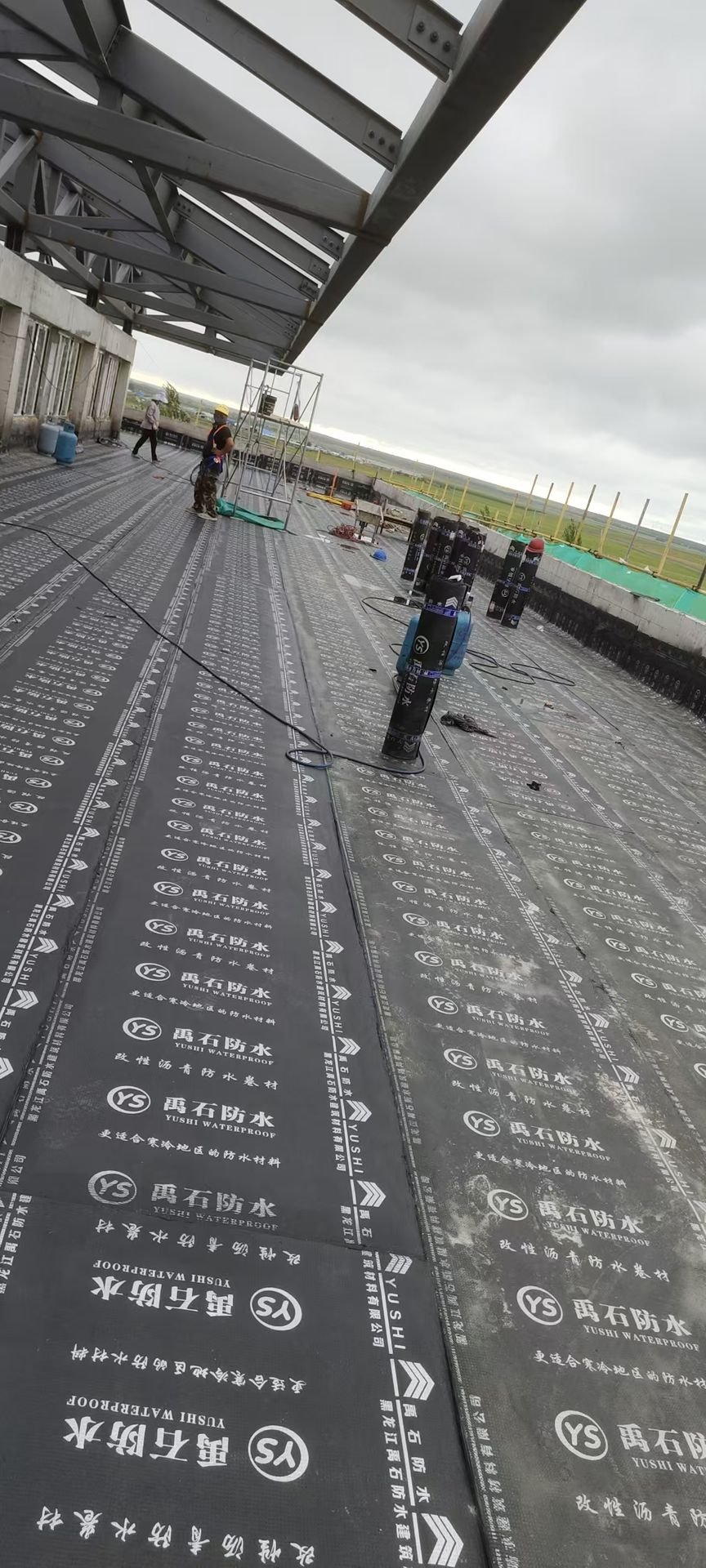SBS waterproofing membrane installation on building rooftop